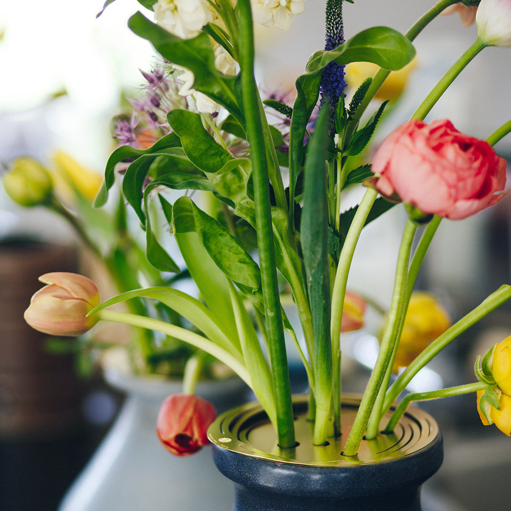Close up of a bouquet being arranged with the Flower Constellation L - brass flower tools designed by House of Thol / photograph by Masha Bakker