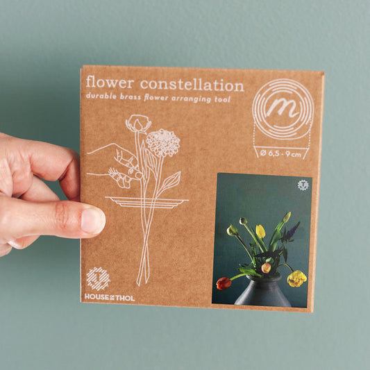 Hand with Cygnus / Flower Constellation M packaging - brass flower tools designed by House of Thol / photograph by Masha Bakker photography
